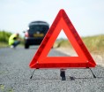 Red warning triangle with a broken down car